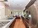 Sleek kitchen with stainless steel appliances and a large island, seamlessly connecting to the living area at 314 Viburnum Way Ct, Charlotte, NC 28208