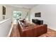 Stylish living room featuring a large leather sofa, modern decor, and an open-concept design at 314 Viburnum Way Ct, Charlotte, NC 28208
