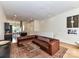 Inviting living room featuring a large leather sofa, hardwood floors, and an open layout at 314 Viburnum Way Ct, Charlotte, NC 28208