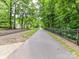 Scenic walking path lined with trees and a fence, perfect for a peaceful stroll at 314 Viburnum Way Ct, Charlotte, NC 28208