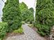 A charming brick walkway winds through lush greenery, leading to a serene escape at 314 Viburnum Way Ct, Charlotte, NC 28208