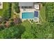 Aerial view of a backyard featuring a swimming pool, hot tub, outdoor seating, and landscaped gardens at 3327 Lakeside Dr, Charlotte, NC 28270