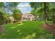 Expansive backyard with covered patio, ideal for outdoor gatherings and enjoying the serene surroundings at 3327 Lakeside Dr, Charlotte, NC 28270