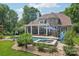 Beautiful backyard featuring a swimming pool, spa, covered patio, and lush landscaping perfect for entertaining at 3327 Lakeside Dr, Charlotte, NC 28270
