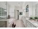 A luxurious primary bathroom features double vanity, soaking tub, glass shower and tiled floors at 3327 Lakeside Dr, Charlotte, NC 28270