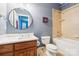 Bathroom with a tub/shower combo, round mirror, and vanity, perfect for relaxation at 3327 Lakeside Dr, Charlotte, NC 28270