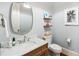 Stylish powder room with marble countertop, wood cabinets, and modern fixtures at 3327 Lakeside Dr, Charlotte, NC 28270