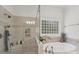 Close up of the soaking tub and separate tiled glass shower in the primary bathroom at 3327 Lakeside Dr, Charlotte, NC 28270