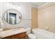 This bathroom offers a tub/shower combo, round mirror, and a vanity with storage at 3327 Lakeside Dr, Charlotte, NC 28270