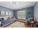 A well-lit bedroom with a couch, hardwood floors, and large windows at 3327 Lakeside Dr, Charlotte, NC 28270