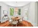 Breakfast nook with hardwood floors, desk, table and windows overlooking the backyard at 3327 Lakeside Dr, Charlotte, NC 28270