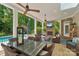 Relaxing covered patio boasts a fireplace, tv, overhead fans, comfortable seating, and outdoor dining area at 3327 Lakeside Dr, Charlotte, NC 28270