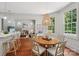 Cozy dining area with a round table, pendant lighting, and views of the living room at 3327 Lakeside Dr, Charlotte, NC 28270