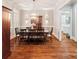 Elegant dining room with hardwood floors, modern chandelier, and seating for eight at 3327 Lakeside Dr, Charlotte, NC 28270