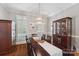 Elegant dining room with a long table, chandelier, and hardwood floors at 3327 Lakeside Dr, Charlotte, NC 28270