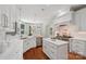 Bright kitchen featuring white cabinets, marble countertops, and a stainless steel stove at 3327 Lakeside Dr, Charlotte, NC 28270