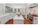 Spacious kitchen with white cabinets, a center island, and stainless steel appliances at 3327 Lakeside Dr, Charlotte, NC 28270