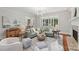 Open living room with hardwood floors, large windows, and comfortable seating at 3327 Lakeside Dr, Charlotte, NC 28270