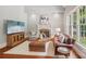 Comfortable living room with a fireplace, hardwood floors, and plenty of natural light at 3327 Lakeside Dr, Charlotte, NC 28270