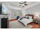 Bright main bedroom with tray ceiling, fan, and hardwood floors features a sitting area and windows at 3327 Lakeside Dr, Charlotte, NC 28270