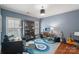 Stylish office features blue walls, hardwood floors, built-in shelves, and a modern desk setup for work and creativity at 3327 Lakeside Dr, Charlotte, NC 28270