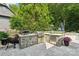 Outdoor kitchen and patio area with a stone facade, ready for outdoor entertainment at 3327 Lakeside Dr, Charlotte, NC 28270