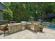 Outdoor kitchen features stainless steel appliances, stone counter, built in grill and ample counter space at 3327 Lakeside Dr, Charlotte, NC 28270