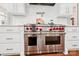 Stainless steel Wolf double oven with red knobs and white cabinets at 3327 Lakeside Dr, Charlotte, NC 28270