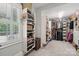 A walk-in closet with custom shelving and natural light from a window at 3327 Lakeside Dr, Charlotte, NC 28270