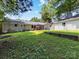 A spacious backyard features a wooden deck, green lawn, and mature trees offering shade and privacy at 3530 Woodleaf Rd, Charlotte, NC 28205