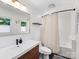 Modern bathroom with a sleek vanity, black hardware, and a shower with tub featuring a neutral-colored curtain at 3530 Woodleaf Rd, Charlotte, NC 28205