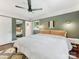 Comfortable bedroom with hardwood floors, natural light, and a full-length mirror on the closet door at 3530 Woodleaf Rd, Charlotte, NC 28205