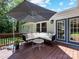 Inviting outdoor deck with comfortable seating, umbrella, and access to the interior at 3530 Woodleaf Rd, Charlotte, NC 28205