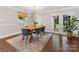 Elegant dining room featuring a modern chandelier, stylish seating for six, and natural light from the French doors at 3530 Woodleaf Rd, Charlotte, NC 28205