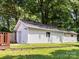 Detached garage with white siding, nestled in a well-maintained backyard at 3530 Woodleaf Rd, Charlotte, NC 28205
