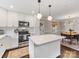 Updated kitchen with white cabinets, stainless steel appliances, and a view into the dining area at 3530 Woodleaf Rd, Charlotte, NC 28205