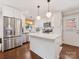Bright, updated kitchen featuring white cabinets, stainless steel appliances, and a large island at 3530 Woodleaf Rd, Charlotte, NC 28205