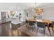 Spacious kitchen and dining area with stainless steel appliances, a breakfast bar island, and a cozy dining table at 3530 Woodleaf Rd, Charlotte, NC 28205