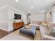 Spacious living room with a large sectional sofa, contemporary cabinet, and hardwood floors at 3530 Woodleaf Rd, Charlotte, NC 28205