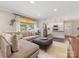 Open concept living room with a large sectional sofa, a view into the modern, white kitchen at 3530 Woodleaf Rd, Charlotte, NC 28205