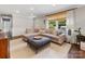 Bright living room featuring a large sectional sofa, stylish ottoman, and lots of natural light at 3530 Woodleaf Rd, Charlotte, NC 28205