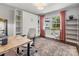 Bright home office with desk, chair, storage shelves, and natural light from the window at 3530 Woodleaf Rd, Charlotte, NC 28205