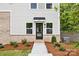 Modern townhome front entrance with brick accents, tidy landscaping, and a welcoming door at 3916 Hager Dr, Charlotte, NC 28208