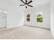 Bedroom with carpeted floors, a ceiling fan, and two windows at 3924 Hager Dr, Charlotte, NC 28208