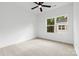 A well-lit bedroom with carpet floors, a ceiling fan, and a large window providing natural light at 3924 Hager Dr, Charlotte, NC 28208