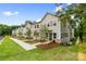 New townhouses featuring manicured front lawns and gray siding with brick accents at 3924 Hager Dr, Charlotte, NC 28208