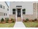 Home exterior showing a brick foundation, stairs to the front door, and a tidy walkway at 3924 Hager Dr, Charlotte, NC 28208