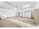 A large, empty garage featuring an open closet and concrete flooring awaits personalization at 3924 Hager Dr, Charlotte, NC 28208