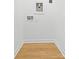 The laundry room featuring wood-look floor, hookups, and neutral paint at 3924 Hager Dr, Charlotte, NC 28208