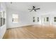 Open living room with light hardwood flooring, recessed lighting, and multiple windows allowing ample sunlight at 3924 Hager Dr, Charlotte, NC 28208